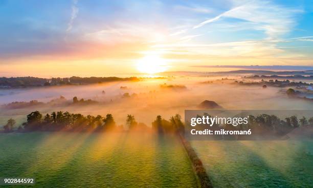 colorfull sunrise on foggy day over tipperary mountains and fields - sunrise foto e immagini stock