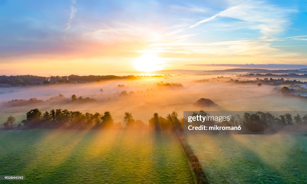 Colorfull sunrise on foggy day over Tipperary mountains and fields