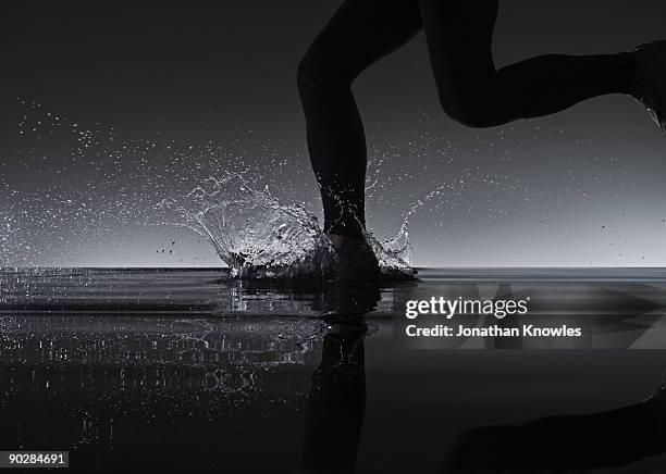 running through water - running legs ストックフォトと画像