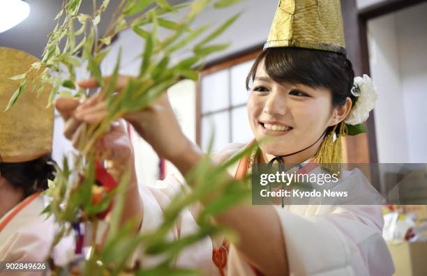 "Fuku musume," or lucky girls, put lucky charms on visitors' bamboo branches at the Imamiya Ebisu Shrine in Osaka on Jan. 9 the first day of the...