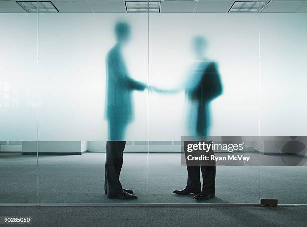 silhouettes of business men shaking hands - handshake silhouette stock pictures, royalty-free photos & images