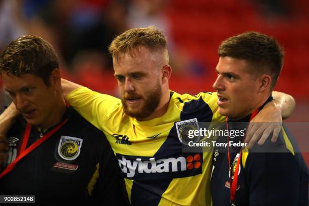 Connor Pain of the Mainers is carried from the ground during the round 15 A-League match between the Newcastle Jets and the Central Coast Mariners at...