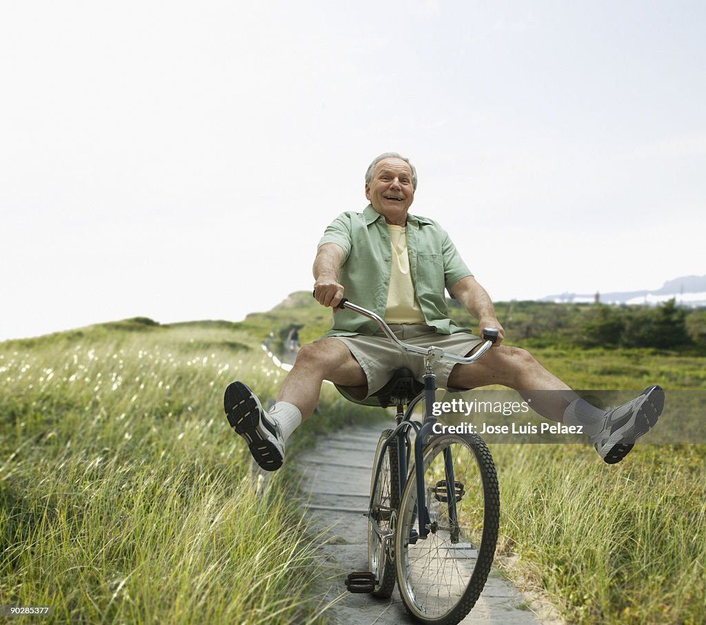 Elderly man riding bicycle