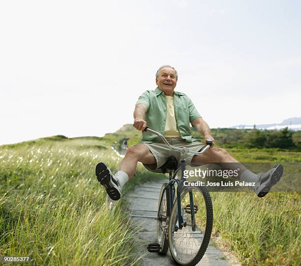 elderly man riding bicycle - excited funny 個照片及圖片檔