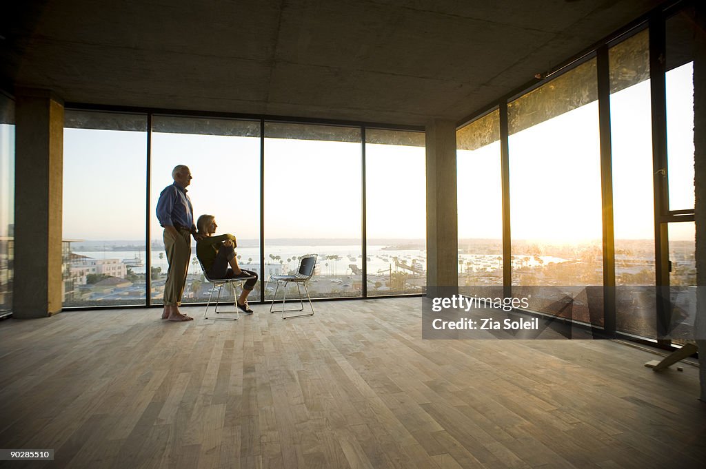 Mature couple in new condo, sunset