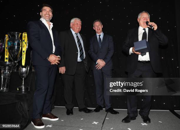Schalk Brits, of Saracens, Tony Rowe, owner of Exeter Chiefs and Rob Howley, Lions assistant coach, look on as Max Boyce talks to the audience after...