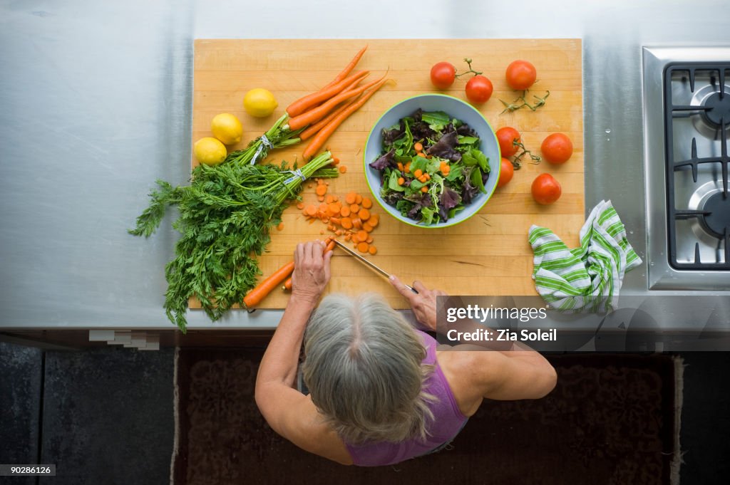 Overhead view, woman making salad