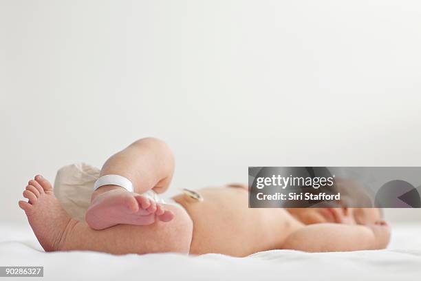 infant baby boy asleep, low angle view - hospital bracelet stock pictures, royalty-free photos & images