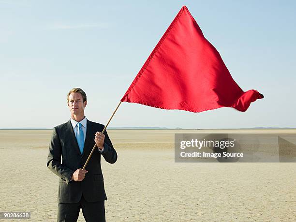 businessman holding a red flag - waving flags stock pictures, royalty-free photos & images