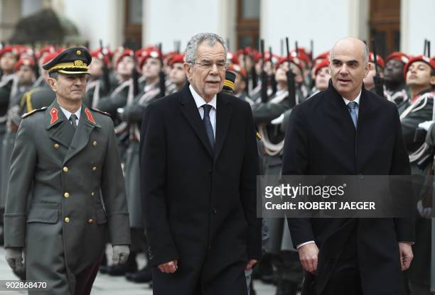 Swiss President Alain Berset and Austrian president Alexander Van der Bellen review troops during a welcoming ceremony on January 9, 2018 in Vienna,...