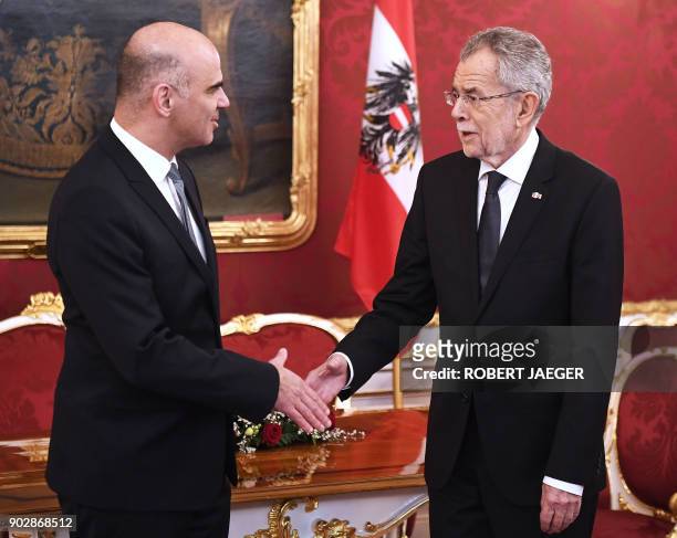 Swiss President Alain Berset shakes hands with Austrian president Alexander Van der Bellen during a meeting on January 9, 2018 in Vienna, Austria....