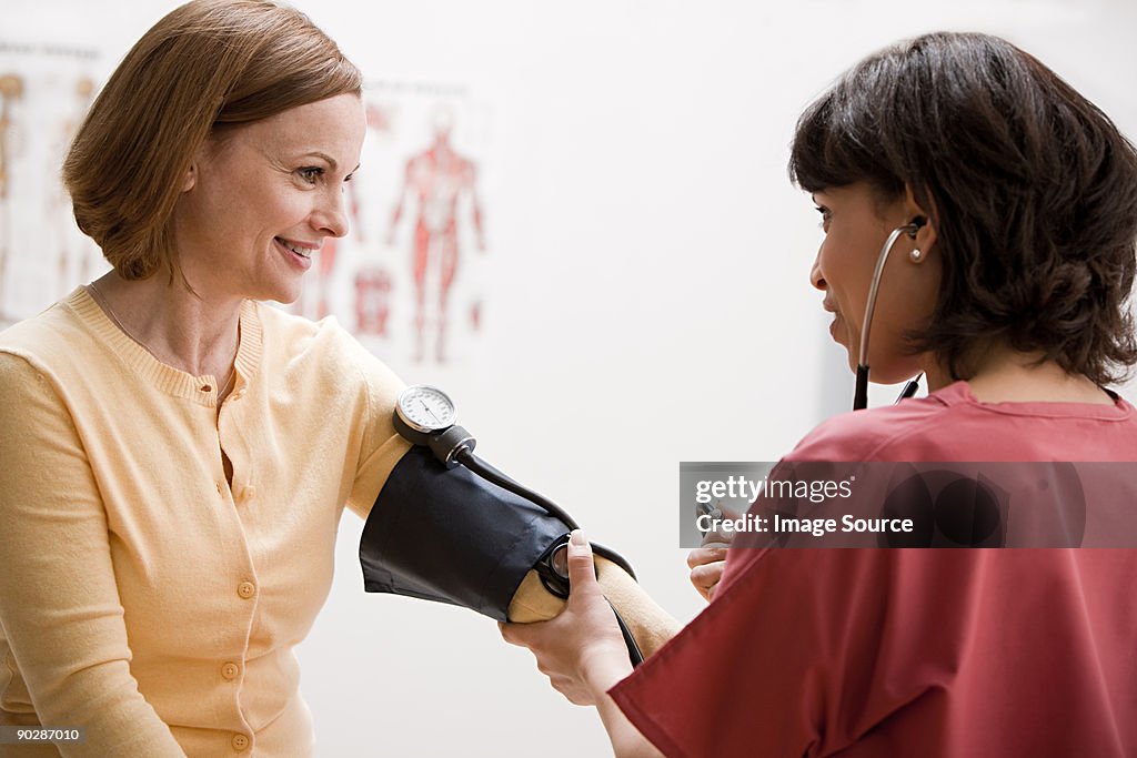 Woman having blood pressure tested