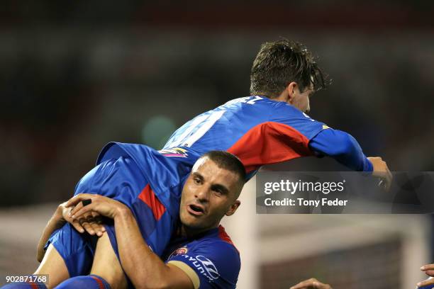 Andrew Nabbout of the Jets picks up team mate Patricio Rodriguez to celebrate a goal during the round 15 A-League match between the Newcastle Jets...