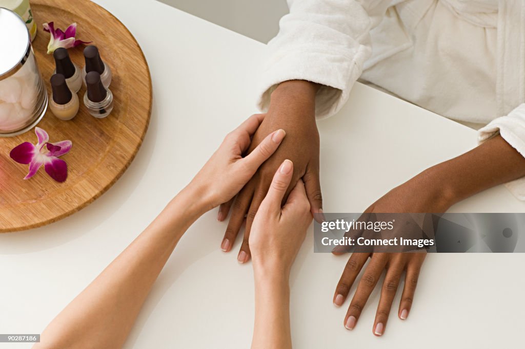 Woman having hands massaged