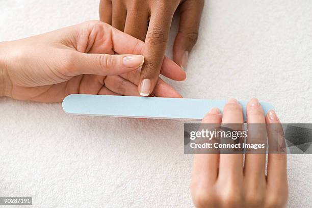 having a manicure - nail file stock pictures, royalty-free photos & images