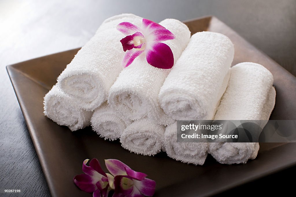 Rolled towels and orchid flowers