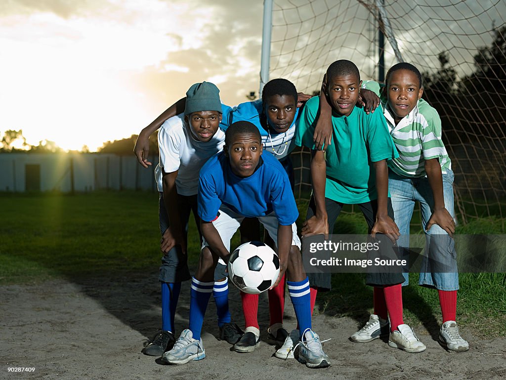 Teenage boys on football pitch