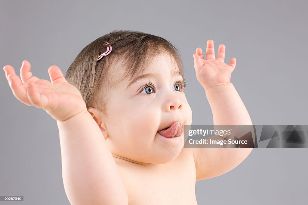 Baby with hands raised