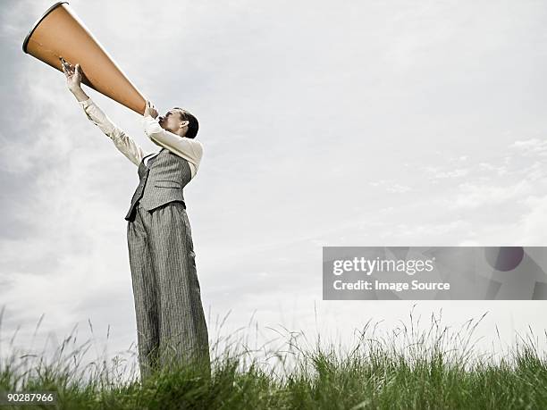 businesswoman with megaphone - women shouting stock pictures, royalty-free photos & images