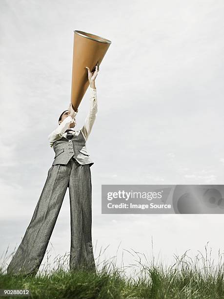 businesswoman with megaphone - megaphone concept stock pictures, royalty-free photos & images