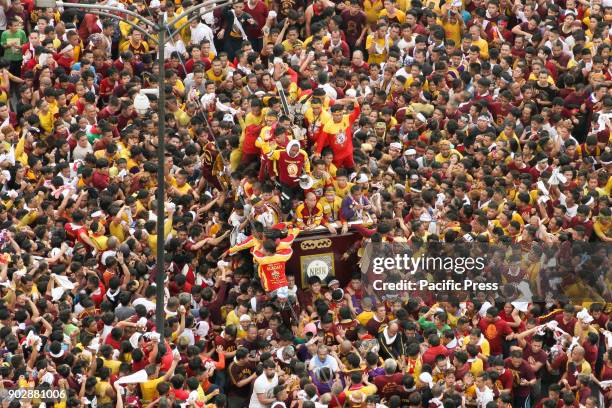 Thousands upon thousands of devotees of the Black Nazarene surround the Icon as it passes by Jones Bridge in Manila.