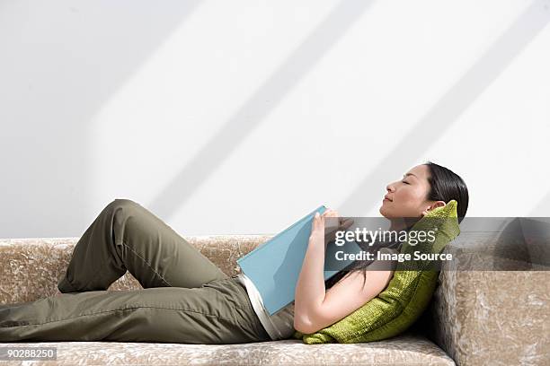 japanese woman sleeping on sofa - supino foto e immagini stock