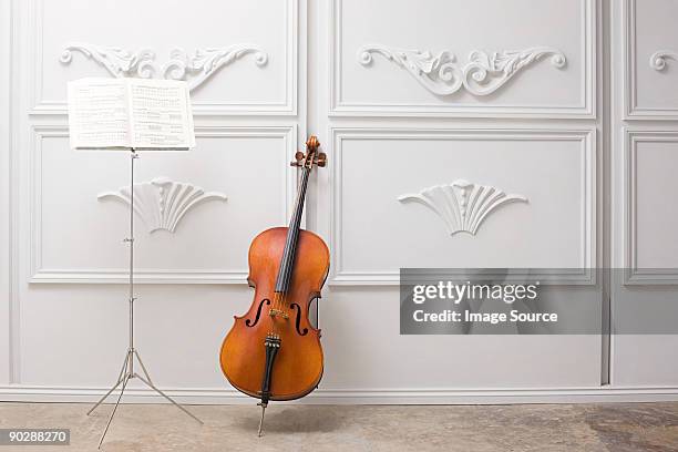 cello and music stand - muziekstandaard stockfoto's en -beelden