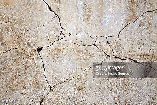 cracked concrete wall - cracked stock pictures, royalty-free photos & images
