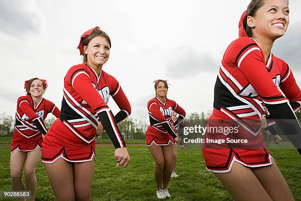 cheerleaders performing routine - asian cheerleaders stock-fotos und bilder