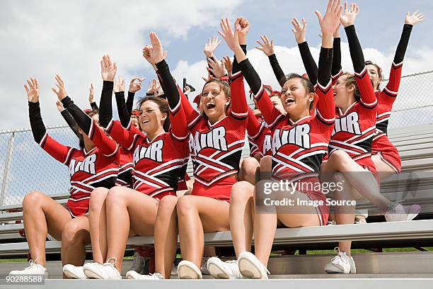 cheerleaders on bleachers - bench dedication stock pictures, royalty-free photos & images