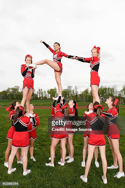 cheerleaders performing routine - asian cheerleaders ストックフォトと画像