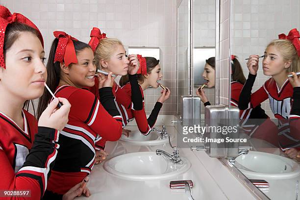 cheerleaders putting on make up - black cheerleaders stock pictures, royalty-free photos & images
