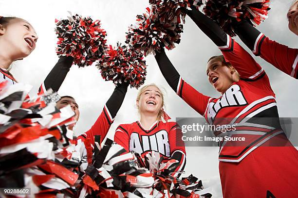 cheerleaders with pom poms - cheerleader stock pictures, royalty-free photos & images