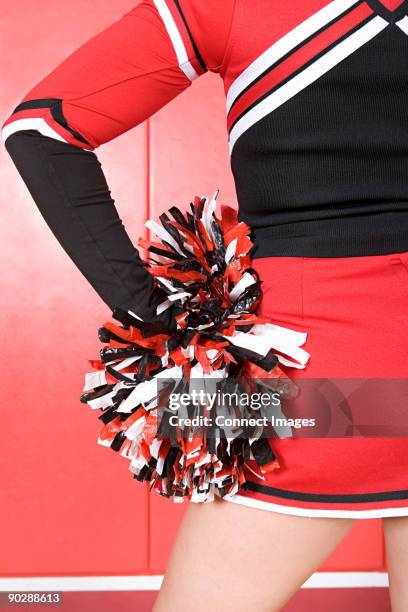 cheerleader with pom pom - cheerleader stockfoto's en -beelden