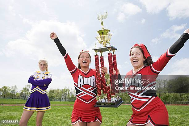 cheerleaders with trophy - teen awards stock-fotos und bilder