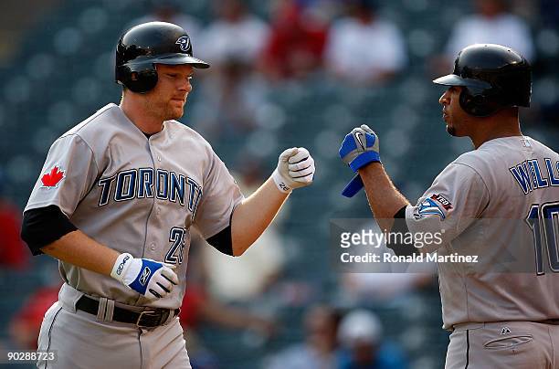 Designated hitter Adam Lind of the Toronto Blue Jays celebrates a home run with Vernon Wells during action against the Texas Rangers on September 1,...