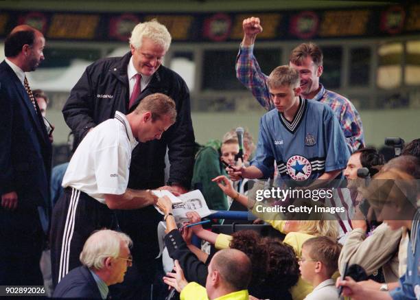 England captain Alan Shearer signs autographs for fans at his unveiling as a Newcastle United player for a then World Record fee of £15 Million at St...