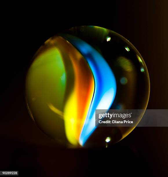 glass marble lit from beneath - glass sphere stock pictures, royalty-free photos & images