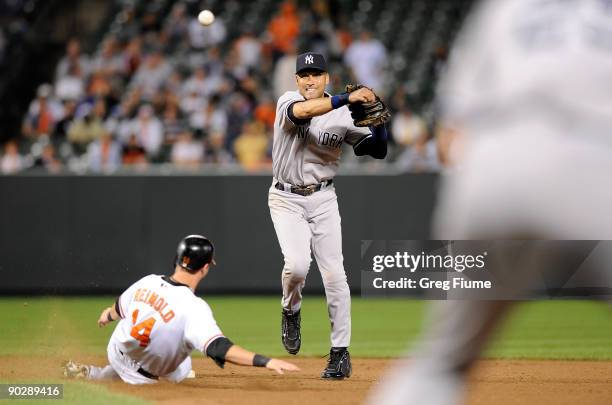 Derek Jeter of the New York Yankees forces out Nolan Reimold of the Baltimore Orioles to start a double play to end the game at Camden Yards on...