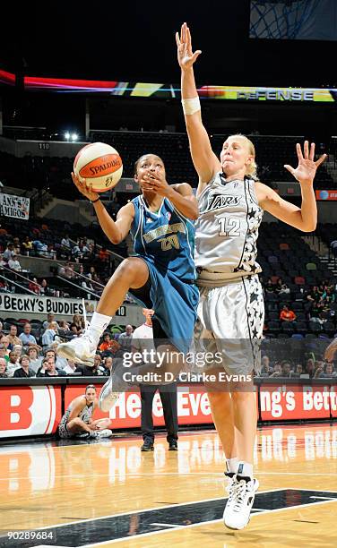 Renee Montgomery of the Minnesota Lynx drives against Ann Wauters of the San Antonio Silver Stars on September 1, 2009 at the AT&T Center in San...