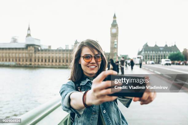 cheerful tourist taking selfie - before they were famous stock pictures, royalty-free photos & images