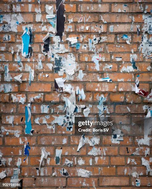 messthetics, brick wall with torn posters - torn canvas stock pictures, royalty-free photos & images