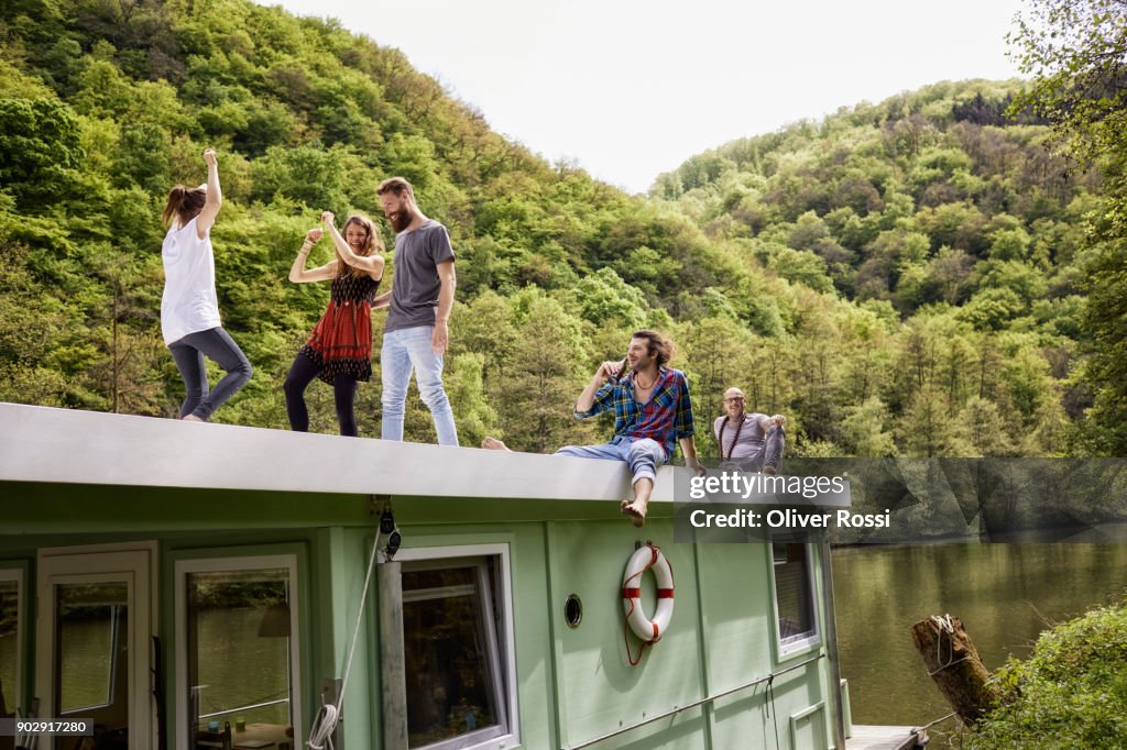 Happy family and friends having fun on a houseboat