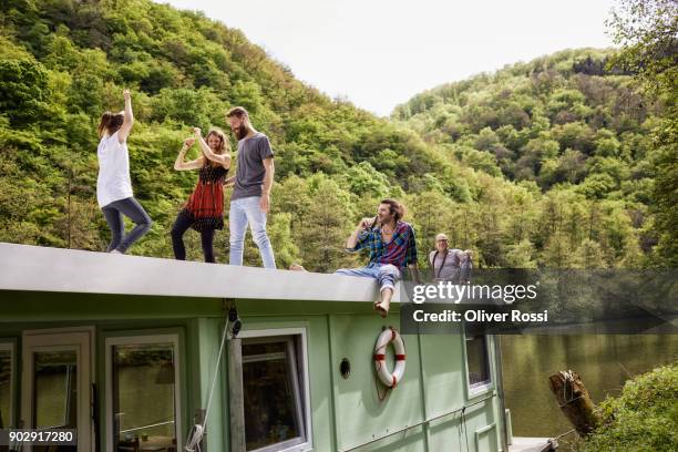 happy family and friends having fun on a houseboat - house boat stock pictures, royalty-free photos & images