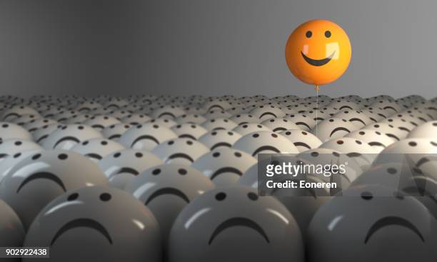 standing out from the crowd with smiling sphere - positive emotion stock pictures, royalty-free photos & images