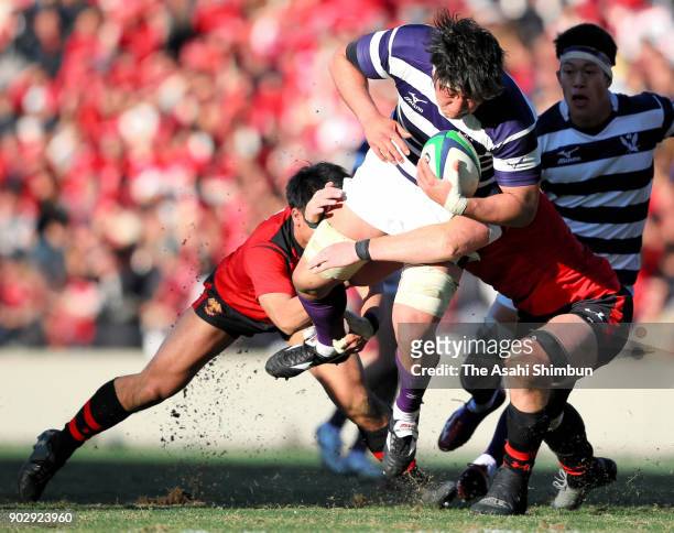 Ryuga Hashimoto of Meiji is tackled during the 54th All Japan University Rugby Championship Final at Teikyo and Meiji at the Prince Chichibu Memorial...