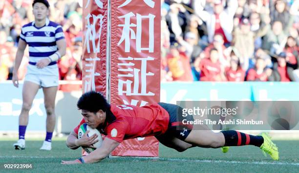 Yuki Okada of Teikyo scores his side's third try with his team mates during the 54th All Japan University Rugby Championship Final at Teikyo and...