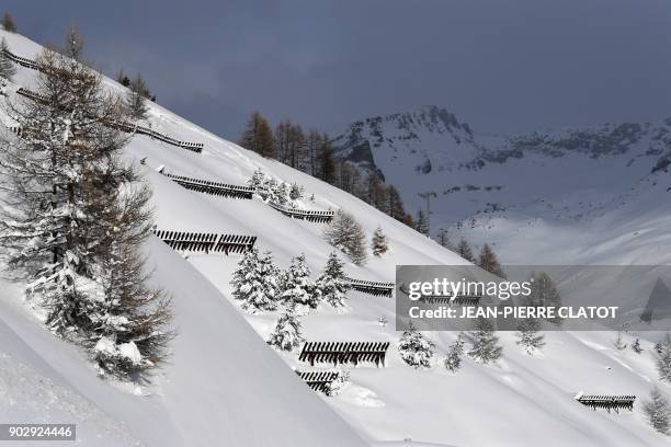 Picture taken on January 9, 2018 shows paravalanches fences protecting the road leading to Tignes ski station, in the French Alps. / AFP PHOTO /...