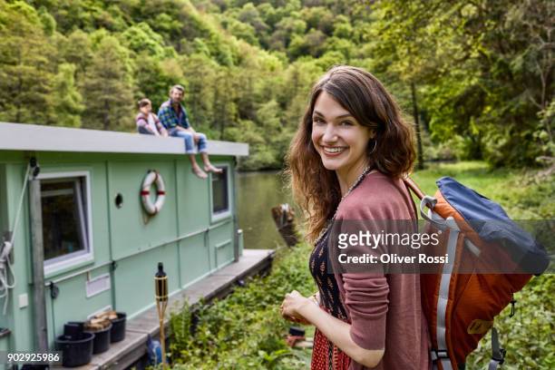 portrait of smiling woman with family on houseboat in background - in touch with nature stock pictures, royalty-free photos & images