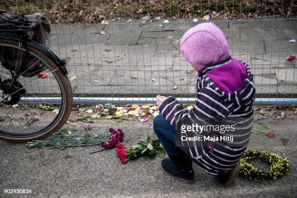 Child places flowers during a demolition of Saint Lambertus church following protests by activists on January 9, 2018 in Immerath, Germany. The...